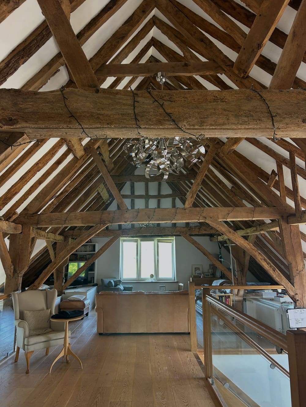 Vaulted barn conversion in West Sussex with exposed oak trusses and freshly plastered panels