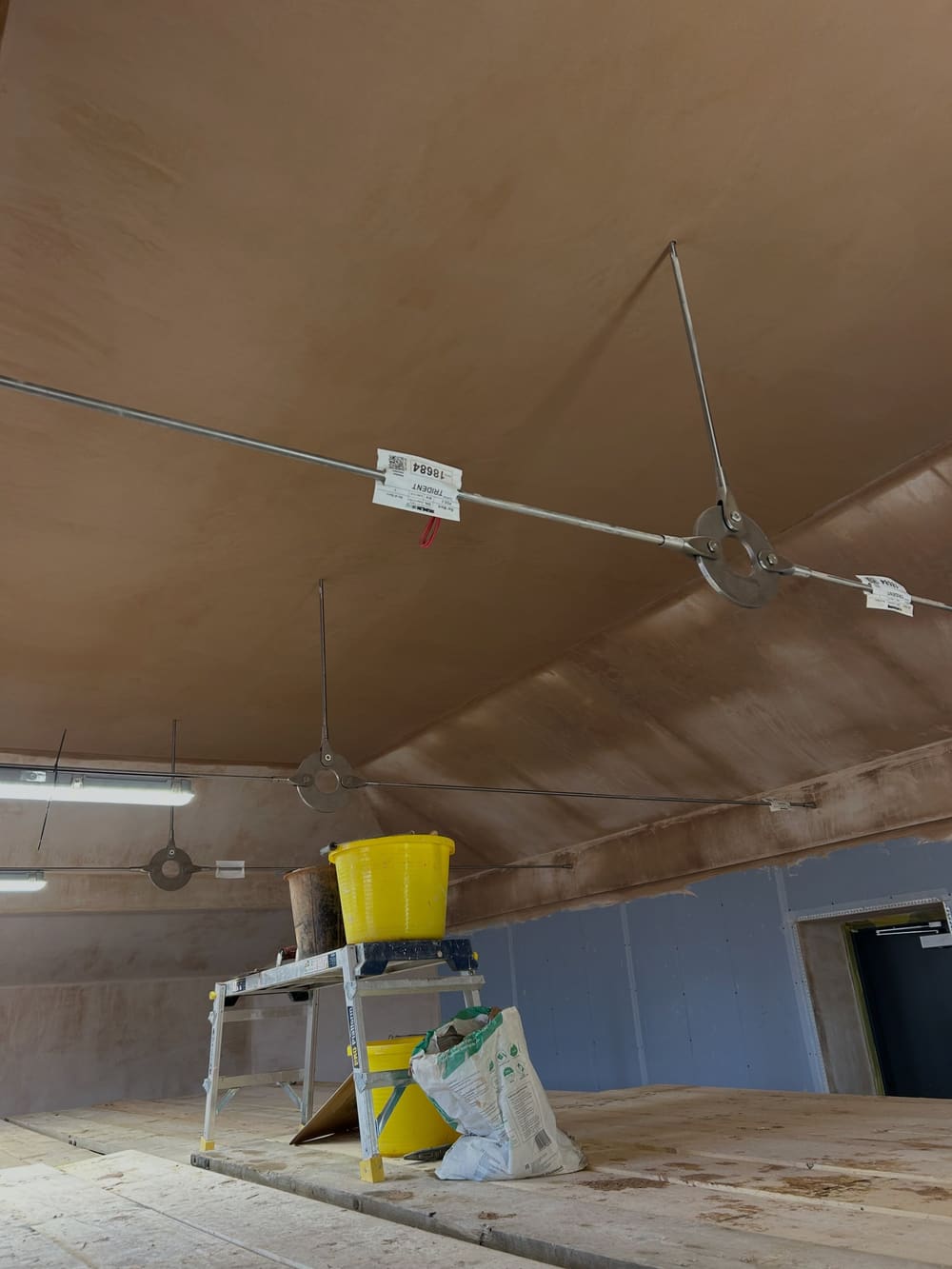 Warm, freshly applied plaster on a barrel-vaulted ceiling in West Sussex